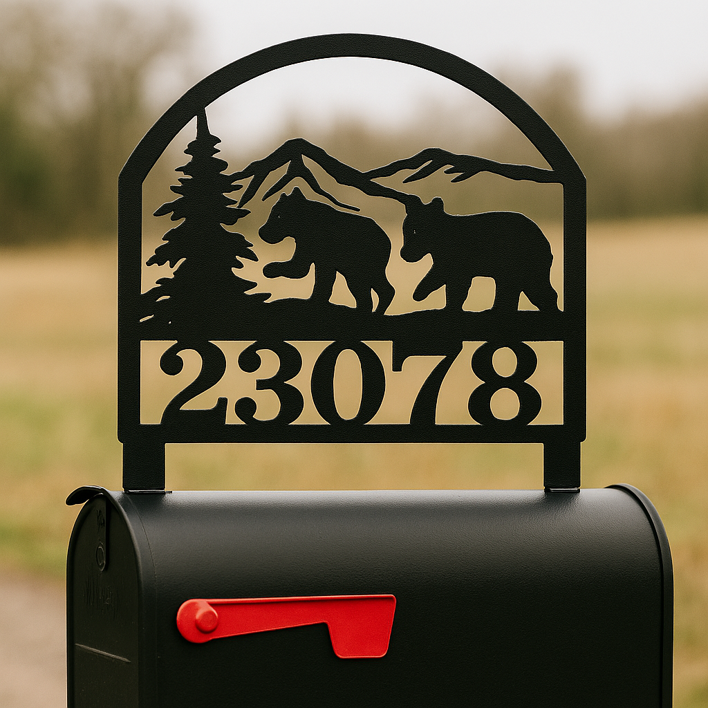 Decorative mailbox with bear and mountain design and house numbers.