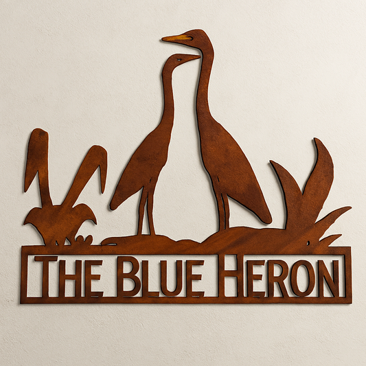 Decorative metal sign with heron design and 'The Blue Heron' text on a beige background