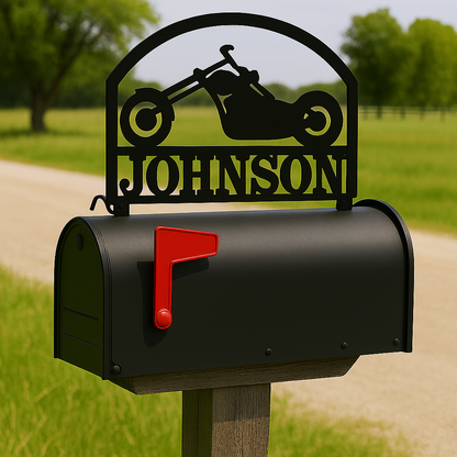 Black mailbox with 'Johnson' personalized nameplate and red flag on a rural background