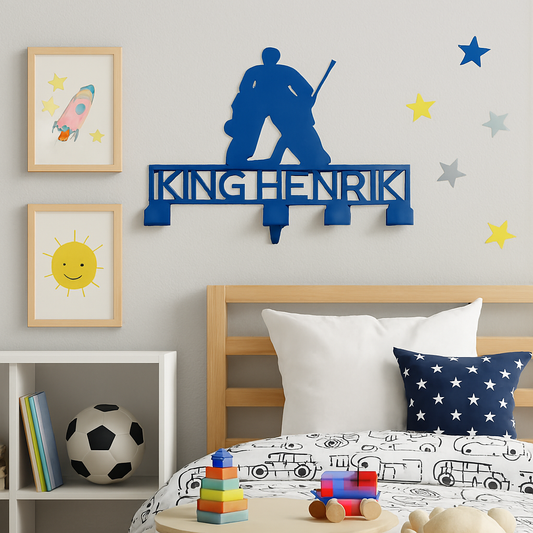 Children's bedroom with a personalized name sign, toys, and wall decorations.
