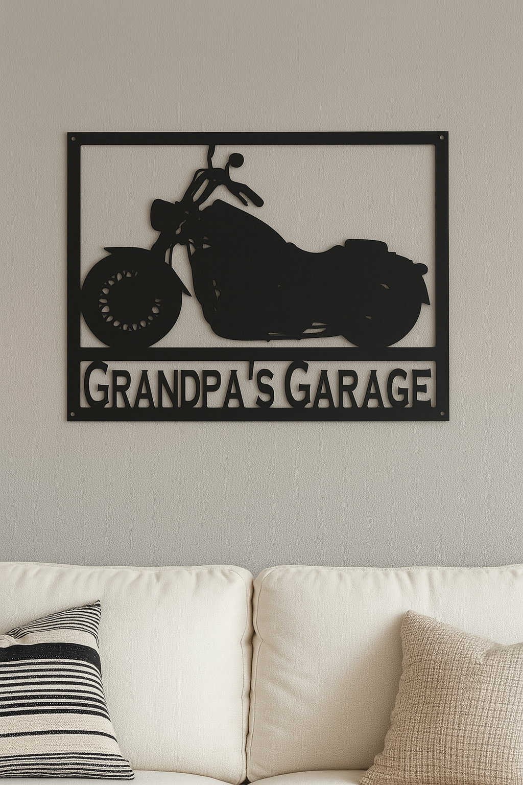 Decorative metal sign with motorcycle design and 'Grandpa's Garage' text on a wall above a sofa.