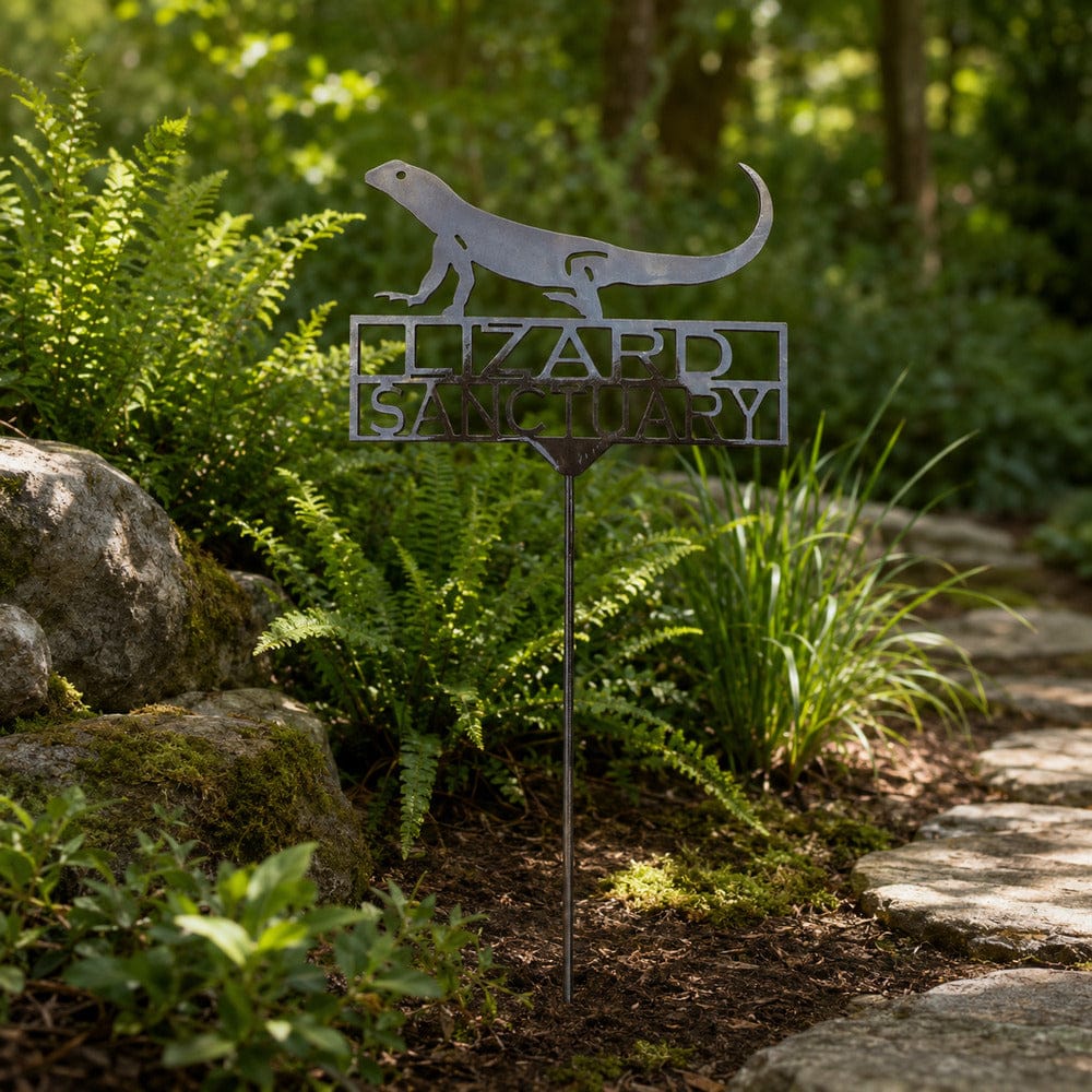 Lizard Sanctuary metal garden stake beside a woodland garden path