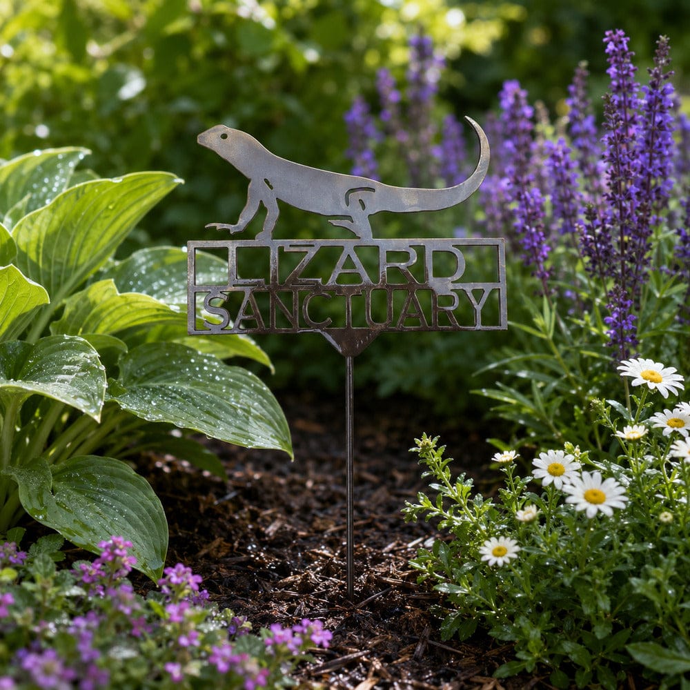 Lizard Sanctuary metal stake displayed among flowers in an outdoor garden bed
