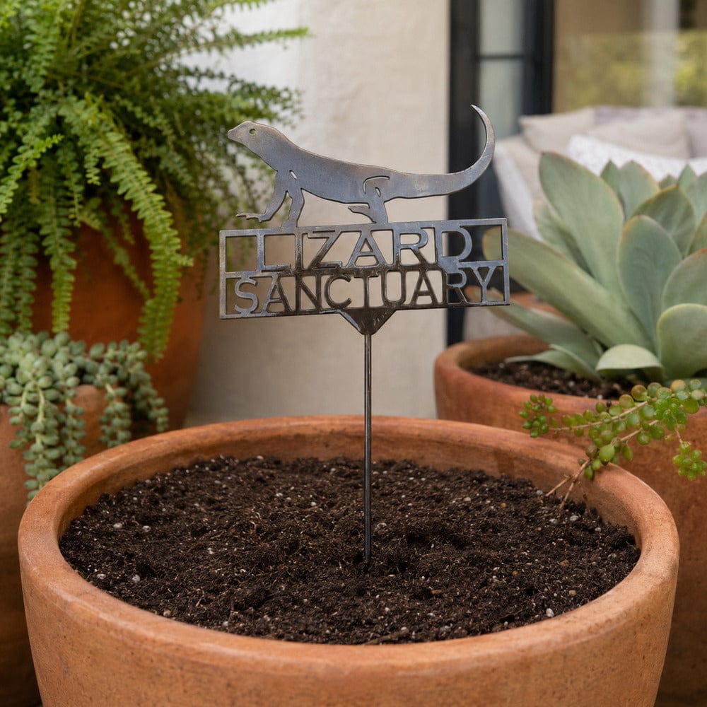 Lizard Sanctuary metal garden stake displayed in a patio planter