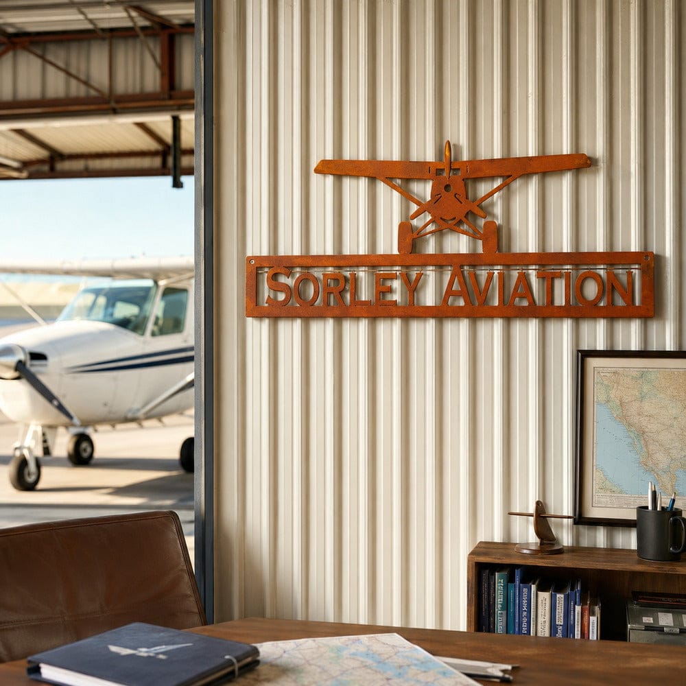 Personalized metal aviation sign with airplane silhouette displayed in an aircraft-themed room