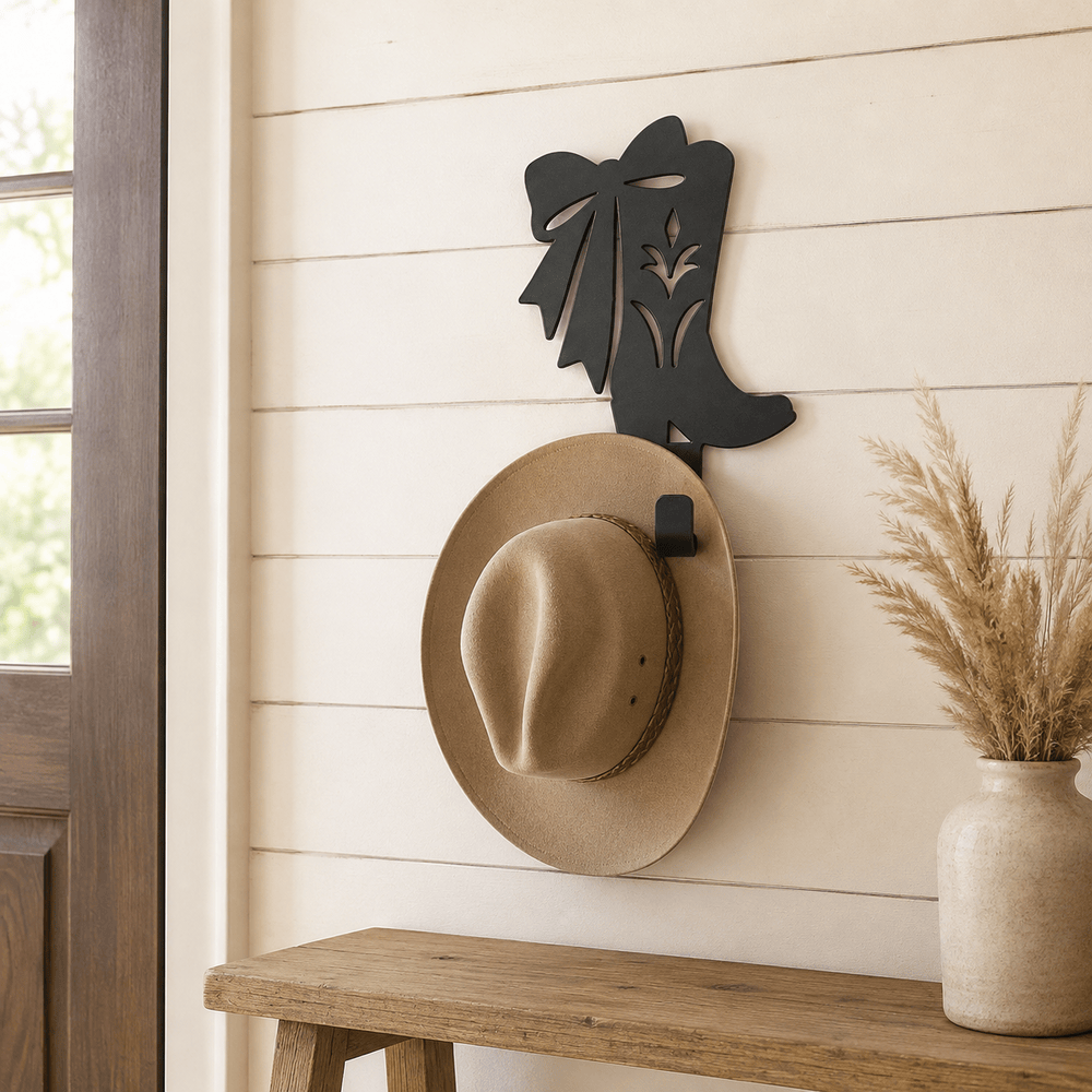 Matte Black D73 cowgirl boot with rolled coat hook holding a Western hat