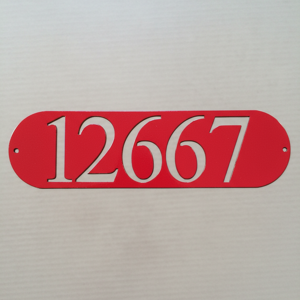 Very close-up of red oval address plaque