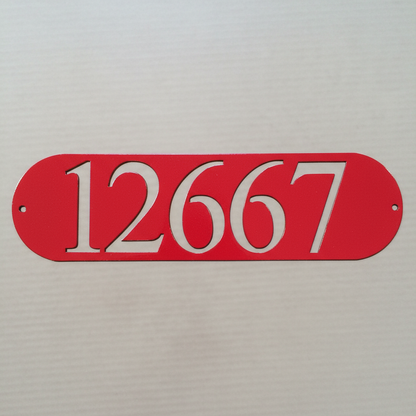 Very close-up of red oval address plaque